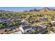 An aerial view showcases a home in a neighborhood with lush landscaping and mountain views in the distance at 4131 E Roma Ave, Phoenix, AZ 85018