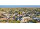 An aerial view showcases a home in a neighborhood with lush landscaping and mountain views in the distance at 4131 E Roma Ave, Phoenix, AZ 85018