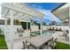 Outdoor living space with built in grill, dining and lounge seating surrounding a pristine pool at 4131 E Roma Ave, Phoenix, AZ 85018
