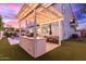 Beautiful backyard featuring a custom kitchen, dining table, lights, pool, lush landscaping and spacious lounge area at 4131 E Roma Ave, Phoenix, AZ 85018