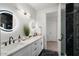 Stylish bathroom boasts double sinks, elegant lighting, and a sleek glass shower at 4131 E Roma Ave, Phoenix, AZ 85018
