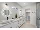 Modern bathroom features double sinks, white cabinets, and a glass enclosed shower at 4131 E Roma Ave, Phoenix, AZ 85018