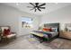 Bright bedroom with a large window, stylish furnishings, and a comfortable bed with decorative pillows at 4131 E Roma Ave, Phoenix, AZ 85018