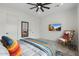 Bright bedroom features a ceiling fan, a mirror, a chair and a TV at 4131 E Roma Ave, Phoenix, AZ 85018