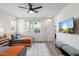 Bright bedroom with two beds, a ceiling fan, and a mounted television at 4131 E Roma Ave, Phoenix, AZ 85018