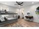 Modern bedroom featuring bunkbeds, a ceiling fan, a bathroom, and a desk at 4131 E Roma Ave, Phoenix, AZ 85018
