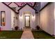 An inviting entrance featuring a dark front door, minimalist potted plants, and a sleek gray walkway at 4131 E Roma Ave, Phoenix, AZ 85018
