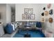 Cozy game room with blue carpet, a corner couch, and unique wall decor at 4131 E Roma Ave, Phoenix, AZ 85018