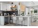 Bright kitchen featuring white cabinets, stainless steel appliances, and a breakfast bar at 4131 E Roma Ave, Phoenix, AZ 85018