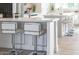 Modern kitchen showcasing white cabinets, a breakfast bar, and an open layout design at 4131 E Roma Ave, Phoenix, AZ 85018
