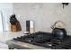 Close-up of a stovetop with a tea kettle and kitchen utensils, offering a glimpse of culinary space at 4131 E Roma Ave, Phoenix, AZ 85018