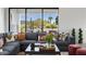 Bright living room featuring a large sectional sofa, stylish decor, and expansive outdoor views at 4131 E Roma Ave, Phoenix, AZ 85018