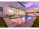 Backyard pool with blue and pink lights, with easy access to dining room and the custom kitchen at 4131 E Roma Ave, Phoenix, AZ 85018