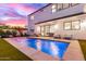 Backyard pool with blue lights and a seating area, perfect for relaxation at 4131 E Roma Ave, Phoenix, AZ 85018