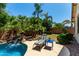 Secluded backyard featuring a waterfall, lush greenery, and a comfortable lounge chair at 418 W Balsam Dr, Chandler, AZ 85248
