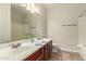 Bright bathroom features double sinks, a large mirror, and a shower-tub combo at 418 W Balsam Dr, Chandler, AZ 85248