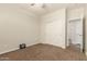 Bedroom with carpeted floor, ceiling fan, and sliding door closet for storage at 418 W Balsam Dr, Chandler, AZ 85248