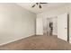 Carpeted bedroom featuring a ceiling fan and doorway leading to another room at 418 W Balsam Dr, Chandler, AZ 85248