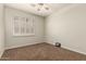 Carpeted bedroom featuring a ceiling fan and a window with shutter style blinds at 418 W Balsam Dr, Chandler, AZ 85248