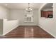Bright dining room features hardwood floors, updated chandelier, and natural light at 418 W Balsam Dr, Chandler, AZ 85248