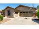 An attached two-car garage with a basketball hoop and low maintenance landscaping at 418 W Balsam Dr, Chandler, AZ 85248