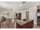 Modern kitchen with hardwood floors, granite countertops, and open concept design at 418 W Balsam Dr, Chandler, AZ 85248