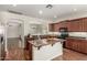 Well-lit kitchen featuring granite countertops, central island, and stainless steel appliances at 418 W Balsam Dr, Chandler, AZ 85248