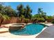 Sparkling pool and spa surrounded by lush landscaping for a private backyard oasis at 418 W Balsam Dr, Chandler, AZ 85248
