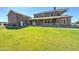 Lush backyard showcasing a beautiful brick home with an inviting covered patio, perfect for outdoor relaxation at 424 E Lehi Rd # 2, Mesa, AZ 85203