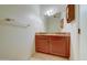 Bathroom featuring a wood vanity with granite countertop, mirror, and tile flooring at 424 E Lehi Rd # 2, Mesa, AZ 85203