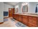 Bathroom featuring dual sinks with wood cabinets and granite countertops at 424 E Lehi Rd # 2, Mesa, AZ 85203