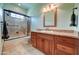 Bathroom featuring a shower with glass doors, wood vanity, granite countertop, and tile flooring at 424 E Lehi Rd # 2, Mesa, AZ 85203