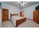Comfortable bedroom featuring a queen bed, wood trim, and soft, neutral carpet at 424 E Lehi Rd # 2, Mesa, AZ 85203