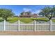 Charming two-story brick home with a white picket fence and lush green lawn at 424 E Lehi Rd # 2, Mesa, AZ 85203