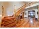 Elegant foyer with wood floors, staircase, chandelier, and views into the living room at 424 E Lehi Rd # 2, Mesa, AZ 85203