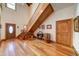 Welcoming foyer with wood floors, staircase, barrel decor and intricate door details at 424 E Lehi Rd # 2, Mesa, AZ 85203