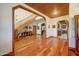 Spacious foyer with wood floors, arched doorways, staircase, and decorative accents at 424 E Lehi Rd # 2, Mesa, AZ 85203