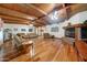 Cozy living room features a wood-paneled ceiling, fireplace, and hardwood floors at 424 E Lehi Rd # 2, Mesa, AZ 85203