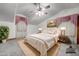 Staged primary bedroom with a plush bed, side tables, lamps, and ample natural light at 424 E Lehi Rd # 2, Mesa, AZ 85203