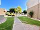 A sidewalk through the green lawn of the community leading to a pool at 4554 E Paradise Village N Pkwy # 133, Phoenix, AZ 85032