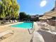 View of the community swimming pool surrounded by chairs and tables for residents at 4554 E Paradise Village N Pkwy # 133, Phoenix, AZ 85032