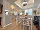 Bright dining area featuring white chairs, modern lighting, and a view into the kitchen at 4554 E Paradise Village N Pkwy # 133, Phoenix, AZ 85032