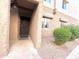 Neutral stucco exterior with security door, close to green shrubbery, offers privacy and curb appeal at 4554 E Paradise Village N Pkwy # 133, Phoenix, AZ 85032