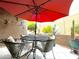 Outdoor patio with patio table, chairs, and an umbrella to block sunlight at 4554 E Paradise Village N Pkwy # 133, Phoenix, AZ 85032