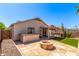 Backyard showcasing the patio, outdoor kitchen, fire pit, and artificial turf at 4731 N 86Th Dr, Phoenix, AZ 85037