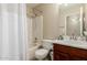 Bright bathroom with a shower-tub combination and a cherry-stained vanity at 4731 N 86Th Dr, Phoenix, AZ 85037