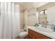Bathroom with white shower curtain, vanity, and a large mirror at 4731 N 86Th Dr, Phoenix, AZ 85037