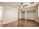 Bedroom with ceiling fan, wood-look floors, and closet doors visible at 4731 N 86Th Dr, Phoenix, AZ 85037