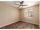 Bedroom with wood-look flooring, ceiling fan, and bright, natural light at 4731 N 86Th Dr, Phoenix, AZ 85037