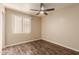 Bedroom featuring wood-look flooring, a ceiling fan, and a window at 4731 N 86Th Dr, Phoenix, AZ 85037
